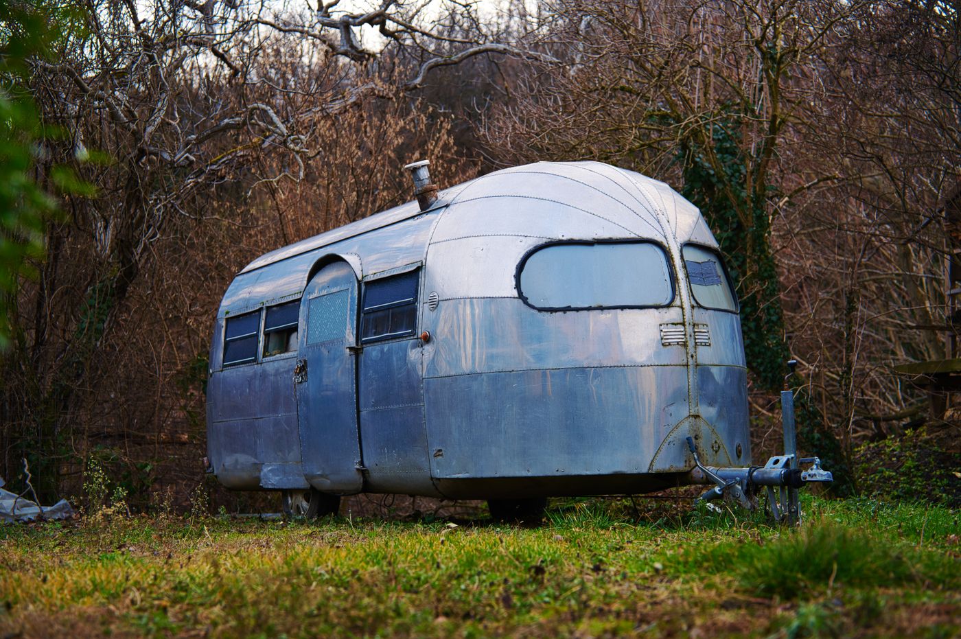 Weathered vintage aluminum camper before restoration